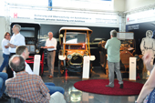 Showroom with classic cars and people
